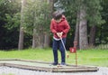 Portrait of Happy child playing mini golf in the park, Active Kid boy playing crazy golf on holiday, Children enjoying his