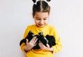 Portrait of a happy child smiling and playing at home with little dog. Pretty little girl cares about the puppy. Happy kid playing Royalty Free Stock Photo