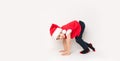 Portrait of happy child standing on the start in Santa Claus hat isolated on white background. 5 year European boy starting run a