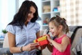 Mom giving gift to girl