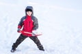 A little boy throws a shovel snow in winter Royalty Free Stock Photo