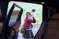 Portrait of a happy child withbackpack on his back move her hand after get off car. Student going to school and waving my parent Royalty Free Stock Photo