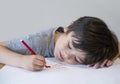 Portrait of happy child writing a messages to his mother, Preschool kid using red colour writing and drawing on white paper, Littl