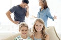 Portrait of happy children - parents arguing in background Royalty Free Stock Photo