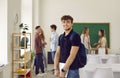 Portrait of happy college or high school boy student with notebook and backpack. Royalty Free Stock Photo