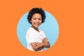 Portrait of happy and confident little boy in white T-shirt standing with crossed hands and smiling Royalty Free Stock Photo