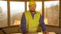 PORTRAIT: Happy contractor smiles after analysing floor plans on a sunny morning Royalty Free Stock Photo