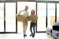 Portrait of happy couple carrying boxes moving into new house Royalty Free Stock Photo