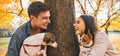 Portrait of happy couple with dogs outdoors in autumn park Royalty Free Stock Photo