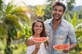 Portrait Of Happy Couple Eating Watermelon Together Cheerful Man And Woman Holding Slice Of Watermelon Outdoors Over Royalty Free Stock Photo