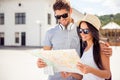 Portrait of happy couple in glasses with cap finding way to town Royalty Free Stock Photo