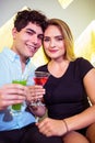 Portrait of happy couple holding cocktail glasses Royalty Free Stock Photo