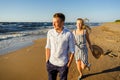 portrait of happy couple in love walking on sandy beach Royalty Free Stock Photo