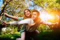 Portrait of happy couple raising their hands in open air