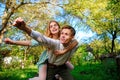 Portrait of happy couple raising their hands in open air