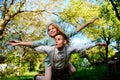 Portrait of happy couple raising their hands in open air