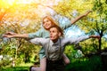 Portrait of happy couple raising their hands in open air