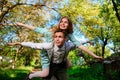 Portrait of happy couple raising their hands in open air