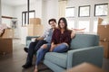 Portrait Of Happy Couple Resting On Sofa Surrounded By Boxes In New Home On Moving Day Royalty Free Stock Photo