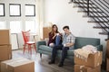 Portrait Of Happy Couple Resting On Sofa Surrounded By Boxes In New Home On Moving Day Royalty Free Stock Photo