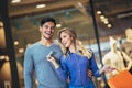 Happy couple showing their new credit card at the mall Royalty Free Stock Photo