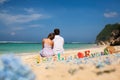 Portrait of Happy Couple, sits on beach with Sea View Royalty Free Stock Photo