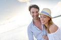 Portrait of happy couple in sunset walking on the beach Royalty Free Stock Photo
