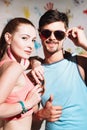 Portrait of happy couple with thumbs up sign on a funny positive background Royalty Free Stock Photo