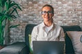 Portrait of happy curly Caucasian businesswoman work on laptop online at home office. smiling young woman employee or worker Royalty Free Stock Photo