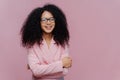 Portrait of happy curly haired businesswoman wears formal jacket, laughs positively, enjoys successful business meeting, has Royalty Free Stock Photo