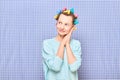 Portrait of happy cute girl with bright colorful hair curlers on head Royalty Free Stock Photo