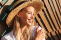 Portrait of happy cute blond woman 20s in straw hat and swimwear Royalty Free Stock Photo