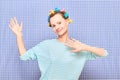 Portrait of happy cute girl with bright colorful hair curlers on head Royalty Free Stock Photo