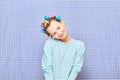 Portrait of happy cute girl with bright colorful hair curlers on head Royalty Free Stock Photo