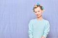 Portrait of happy cute girl with bright colorful hair curlers on head Royalty Free Stock Photo