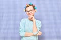 Portrait of happy cute girl with bright colorful hair curlers on head Royalty Free Stock Photo