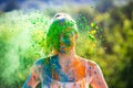 Portrait of happy cute girl on holi color festival of colors. Color powder on faces and body.