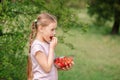 Portrait of Happy cute little girl is eating strawberries at summer day. Soft focused Royalty Free Stock Photo