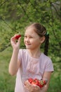 Portrait of Happy cute little girl is eating strawberries at summer day. Soft focused Royalty Free Stock Photo