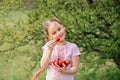 Portrait of Happy cute little girl is eating strawberries at summer day. Soft focused Royalty Free Stock Photo