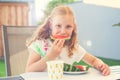 Portrait of happy cute little girl eating sweet red watermelonin garden Royalty Free Stock Photo