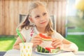 Portrait of happy cute little girl eating sweet red watermelonin garden Royalty Free Stock Photo