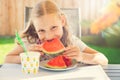 Portrait of happy cute little girl eating sweet red watermelonin garden Royalty Free Stock Photo