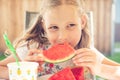 Portrait of happy cute little girl eating sweet red watermelonin garden Royalty Free Stock Photo