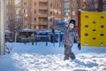 Portrait of happy cute little kid boy in colorful warm winter fashion clothes. Funny child having fun in forest or park on cold da Royalty Free Stock Photo