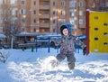 Portrait of happy cute little kid boy in colorful warm winter fashion clothes. Funny child having fun in forest or park on cold da Royalty Free Stock Photo