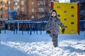 Portrait of happy cute little kid boy in colorful warm winter fashion clothes. Funny child having fun in forest or park on cold da Royalty Free Stock Photo