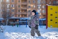 Portrait of happy cute little kid boy in colorful warm winter fashion clothes. Funny child having fun in forest or park on cold da Royalty Free Stock Photo