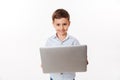 Portrait of a happy cute little kid holding laptop computer Royalty Free Stock Photo