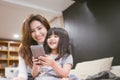 Portrait Happy Daughter playing smartphone with her mother. Royalty Free Stock Photo